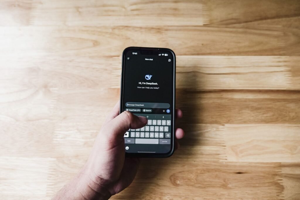 A person using a smartphone with a digital assistant on screen