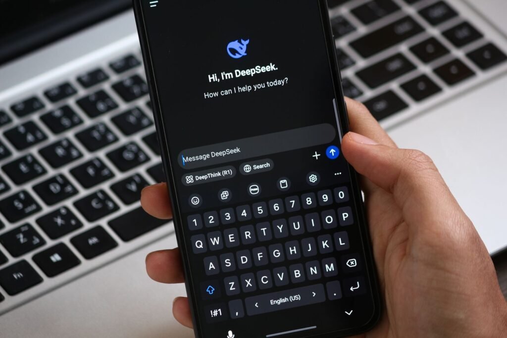 A person holding a smartphone showing an AI chat interface