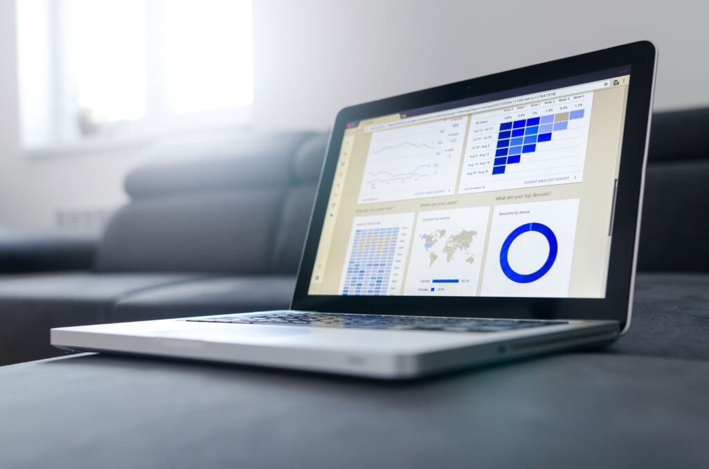 A laptop displaying data analytics graphs and charts